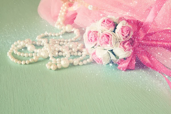 Small girls party outfit: crown and wand flowers on wooden table. bridesmaid or fairy costume. vintage filtered with glitter overlay. selective focus — Stockfoto