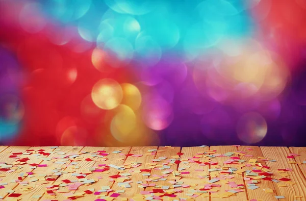 Roze partij fluit van houten tafel met kleurrijke confetti. Vintage gefilterde afbeelding — Stockfoto