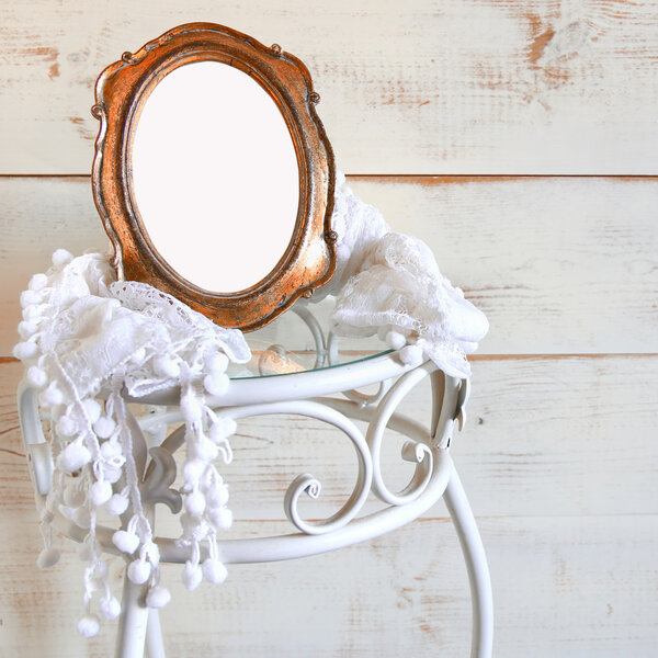 Antique blank vintage style frame and white scarf on elegant table. template, ready to put photography. vintage filtered