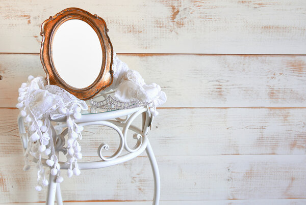 Antique blank vintage style frame and tiara on elegant table. template, ready to put photography. vintage filtered