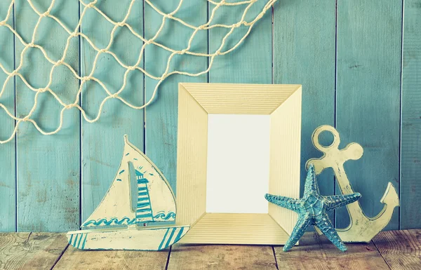 Nautical life style objects next to blank frameon wooden table. vintage filtered — Stock Photo, Image