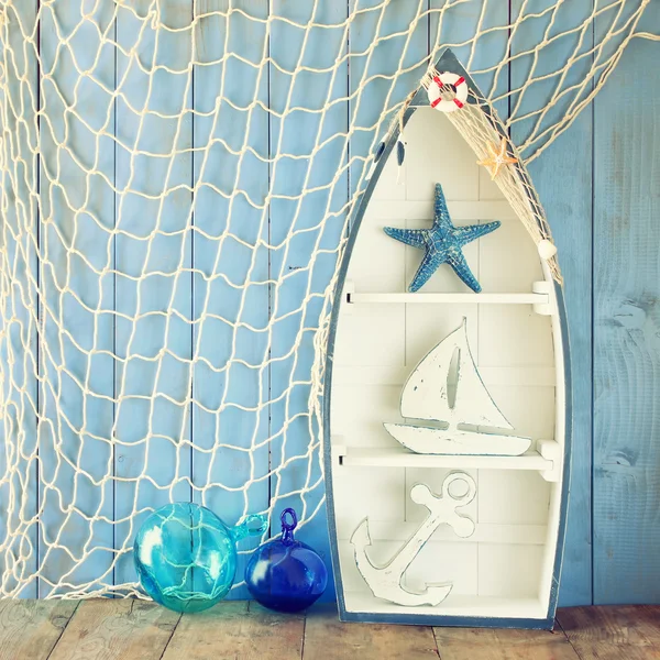 Nautical boat shape shelves and nautical life style objects on wooden table. vintage filtered — Stock Photo, Image