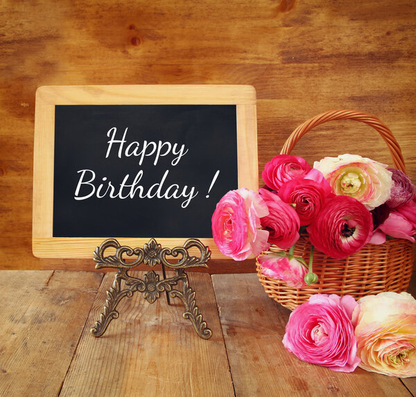 цветы рядом с доской с фразой: С днем рождения, на дереве
