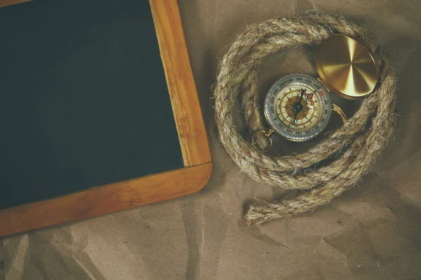 Top view of compass, rope and blank blackboard — Stock Photo, Image