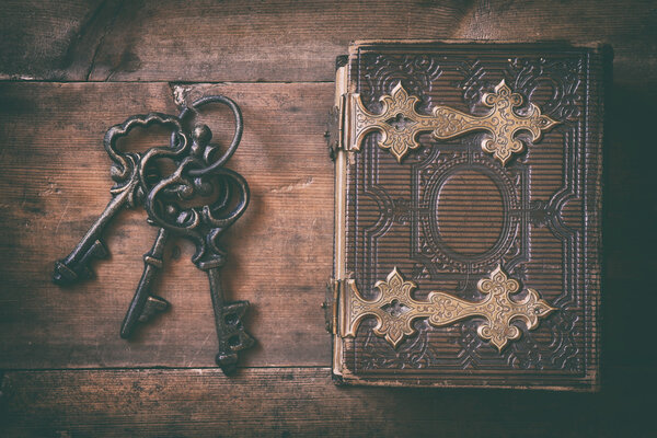 top view of antique book cover and old keys