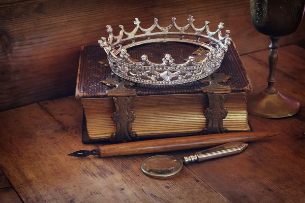 Low key image of diamond queen crown on old book — Stock Photo, Image