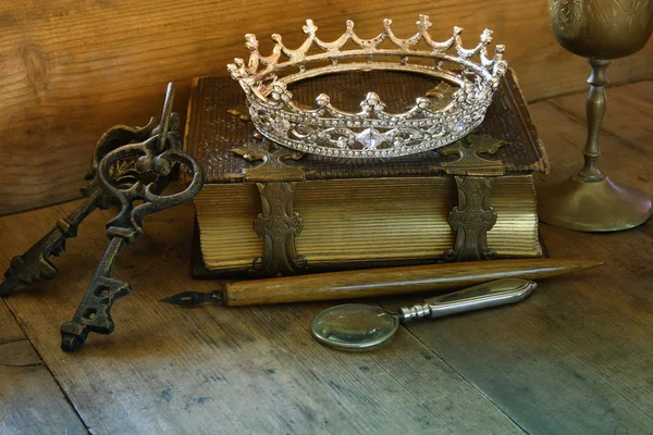 low key image of diamond queen crown on old book