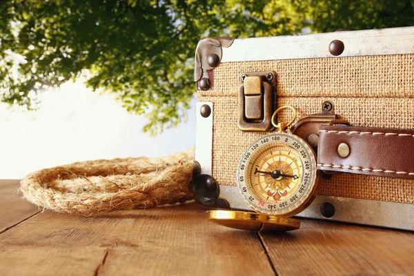 Traveler vintage luggage and compass on wooden table — Stock Photo, Image