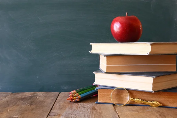 Back to school concept. Blackboard with books — Stock Photo, Image