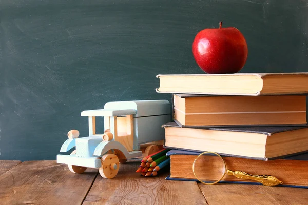 Back to school concept. Blackboard with books — Stock Photo, Image