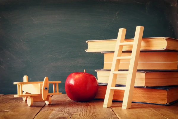 Back to school concept. Blackboard with books — Stock Photo, Image