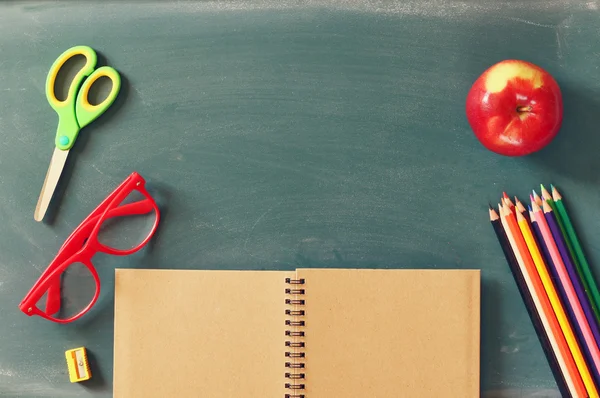 Back to school concept. school supplies on blank blackboard — Stock Photo, Image