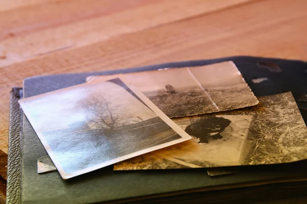 Antique photos and old album on wooden table — Stock Photo, Image