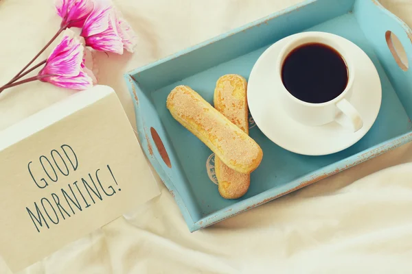 Romantic breakfast in the bed: cookies, hot coffee, flowers — Stock Photo, Image