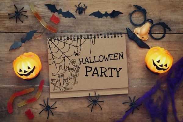 Halloween concept. Pumpkins, spiders, bats and notebook — Stock Photo, Image
