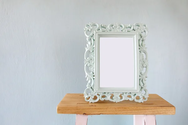 Vintage antique classical frame on wooden table — Stock Photo, Image