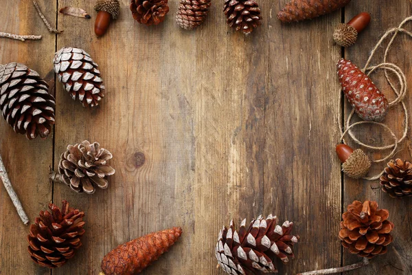 Top view of pine cones on rustic wooden background — Stock Photo, Image