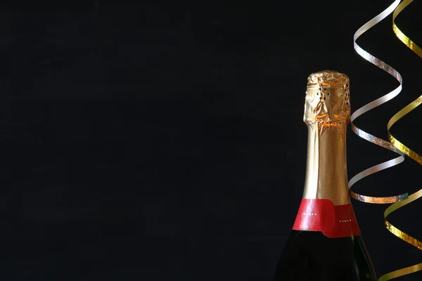 Siyah arka plan önünde şampanya şişesi — Stok fotoğraf