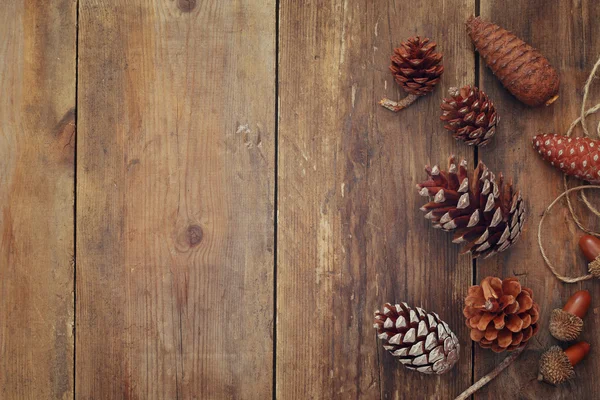 Top view of pine cones on wooden background — Stock Photo, Image