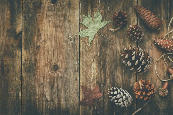 Top view of pine cones on wooden background — Stock Photo, Image