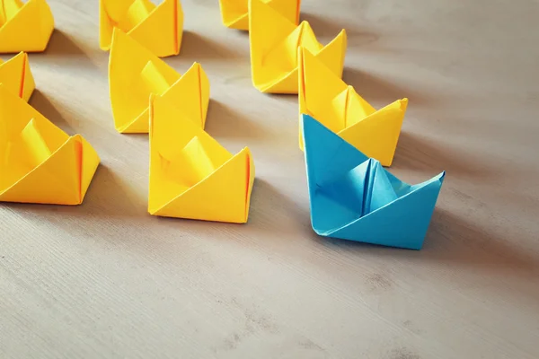 Leadership concept with paper boats on wooden background — Stock Photo, Image