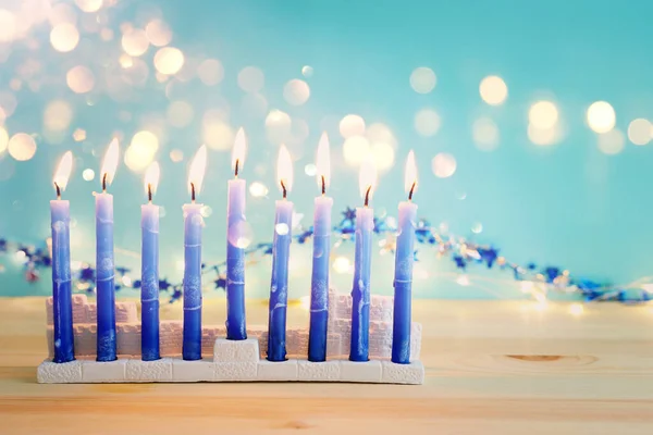 Religion image of jewish holiday Hanukkah background with menorah (traditional candelabra) and candles