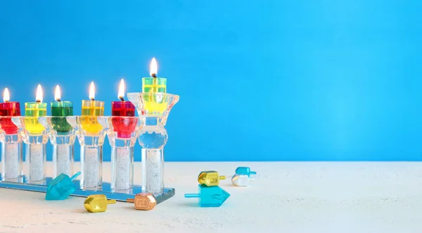 Religion image of jewish holiday Hanukkah background with menorah (traditional candelabra) and candle