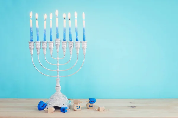 Religion image of jewish holiday Hanukkah background with menorah (traditional candelabra) and candles