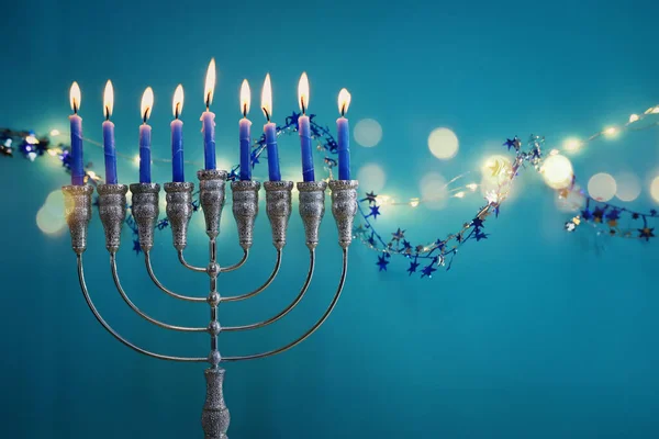 Religion image of jewish holiday Hanukkah background with menorah (traditional candelabra) and candles