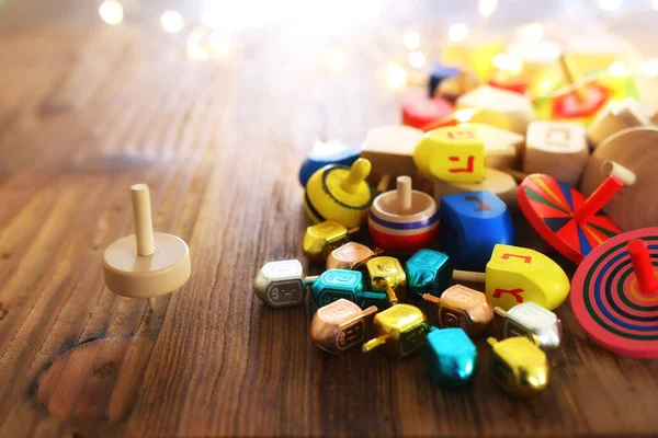 Banner of jewish holiday Hanukkah with wooden dreidels (spinning top) over wooden background