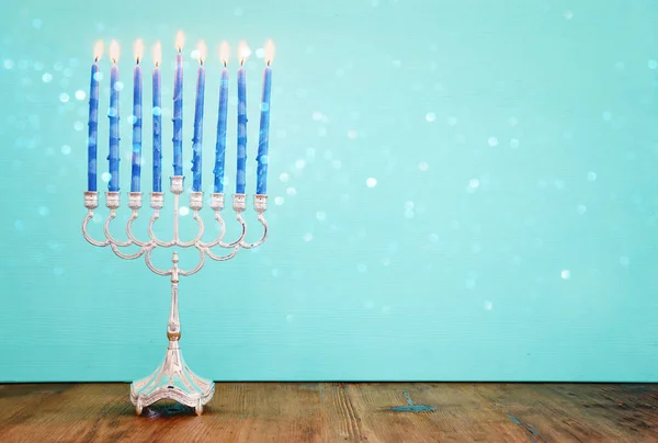 Religion image of jewish holiday Hanukkah background with menorah (traditional candelabra) and candles