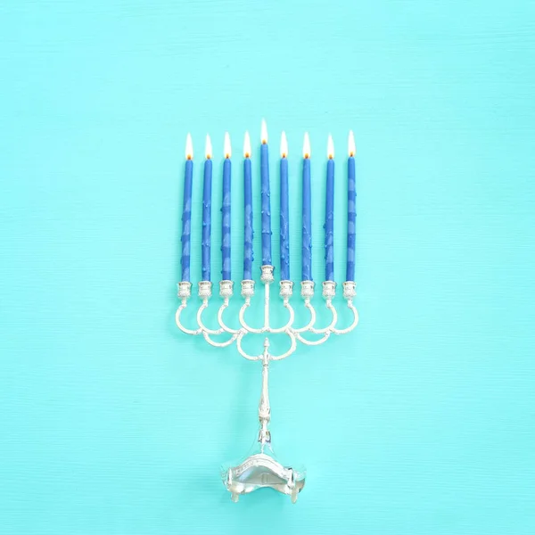 Religion image of jewish holiday Hanukkah background with menorah (traditional candelabra) and candles