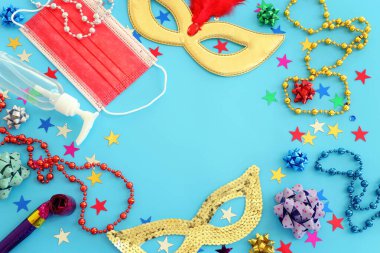 Top view image of masquerade mask background. Flat lay. Purim celebration (jewish carnival holiday). Coronavirus prevention concept, medical mask and and sanitizer gel clipart