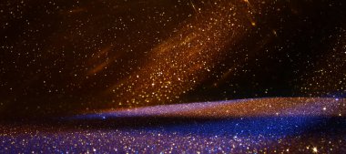 Soyut altın ve siyah parıltılı ışıkların arkaplanı. Odaklanamadı