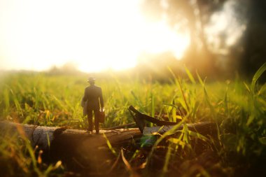 Gün batımında yalnız yürüyen gizemli bir adamın gerçeküstü görüntüsü.