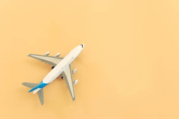 top view photo of airplane over pastel yellow background