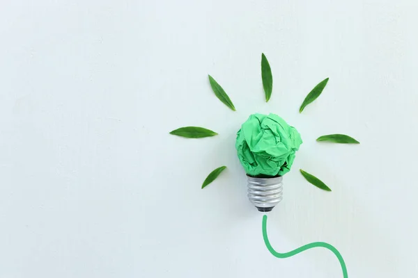 Concept image if green crumpled paper lightbulb, symbol of scr, innovation and eco friendly business