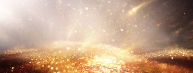 Soyut altın ve siyah parıltılı ışıkların arkaplanı. Odaklanamadı