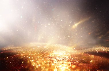 Soyut altın ve siyah parıltılı ışıkların arkaplanı. Odaklanamadı