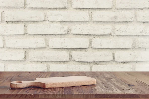 empty table board and brick wall background. product display concept