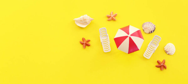 праздники вид сверху на тропический пляж со стульями под зонтиками. Летние путешествия и отдых