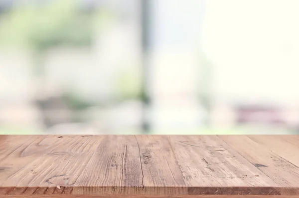 empty table board and defocused indoor background. product display concept