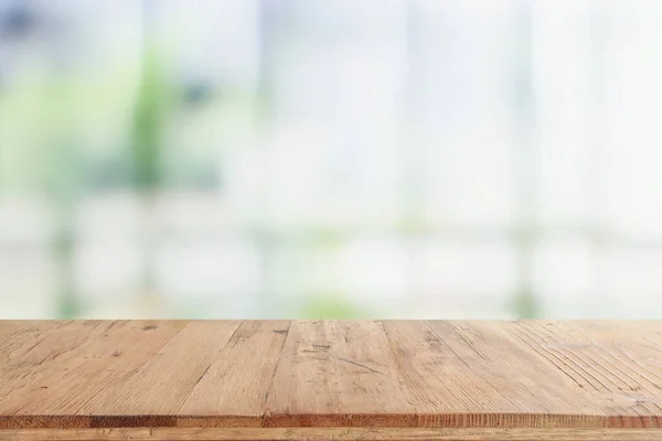 empty table board and defocused indoor background. product display concept