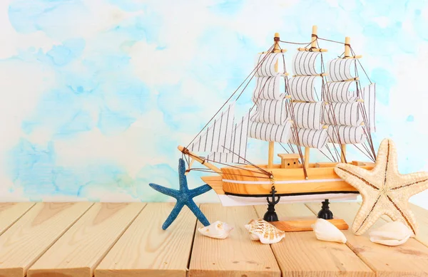 Nautical Concept Decorative Sail Boat Seashells Wooden Table Blue Background — Stock Photo, Image