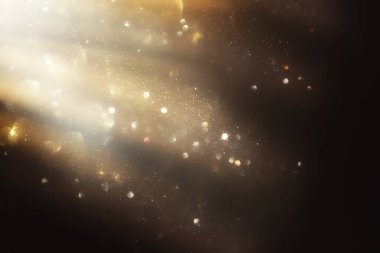 Soyut altın ve siyah parıltılı ışıkların arkaplanı. Odaklanamadı