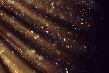 Soyut altın ve siyah parıltılı ışıkların arkaplanı. Odaklanamadı