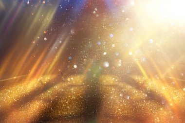 Soyut altın ve siyah parıltılı ışıkların arkaplanı. Odaklanamadı
