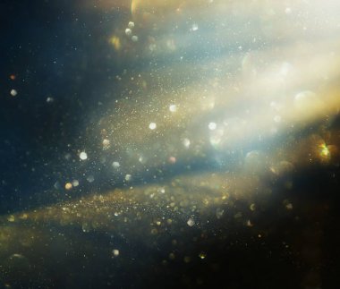 Soyut parıltılı ışıkların arkaplanı. Altın, mavi ve siyah. & Odaklan