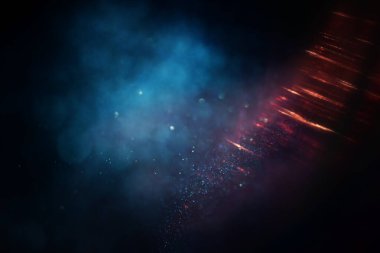 Soyut parıltılı ışıkların arkaplanı. Altın, mavi ve siyah. & Odaklan