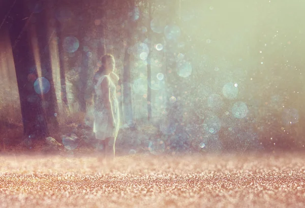 Surreal photo of young woman standing in forest. image is textured and toned — Stock Photo, Image